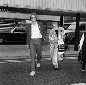 01032 Prints: Shirley MacLaine leaving Heathrow Airport for Washington being seen off by Charles Dance