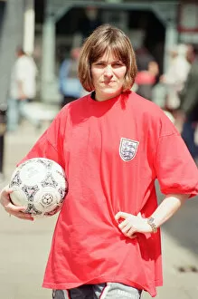 Images Dated 25th June 1996: Shop asistant Karen Burke from Soccer City, models Englands old Red Strip, Liverpool