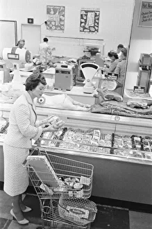 Meat Prints: Shopper browsing the butchers counter at a newly opened self service food store in North