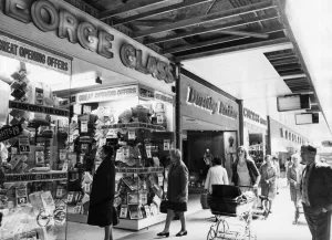 Shoppers browsing through shop windows at the new Salford City Shopping Centre