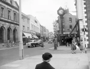 00174 Prints: Shoppers and cars mingle on the busy High Street in Stourbridge. 1958