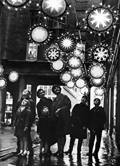 Illuminations Prints: Shoppers enjoy a preview of the Christmas illuminations in the Minories outside Lewis