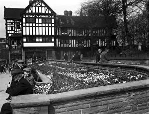 Shoppers enjoy the spring sunshine and the flower beds outside Timothy Whites in Trinity