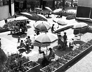 00088 Prints: Shoppers relaxing below the circular Godiva Cafe in the Lower Precinct