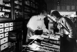 Customer Prints: Shopping during Powercuts, James Taylor is able to keep his pharmacy open by using
