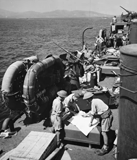 Battleship Prints: Within sight of the coast of France R. A. F. airmen study a map map at sea during Second
