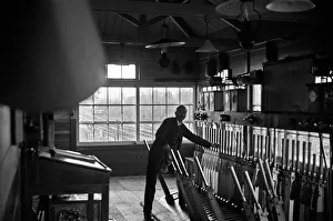 Outer London Prints: Signalman working in an unknown signal box on the Woking to Waterloo line. November 1938