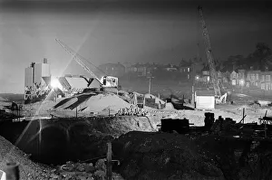 Silent cranes reach over what is usually a scene of intense activity by day - the site of