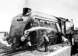 Simmering in a shed yard, No. 60022 Mallard gets a check from its crew in March 1965