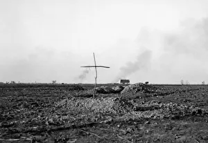 Grave Prints: A simple cross marks the spot of a grave of a Belgian soldier killed during the fighting