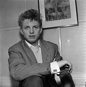 Singer and actor Tommy Steele showing of this Rock n Roll cufflinks