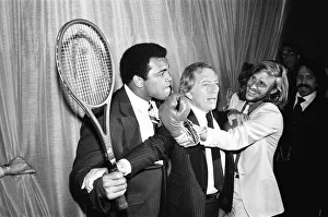 00328 Prints: Singer Andy Williams breaks steps inbetween Heavyweight Boxing champion who is holding a