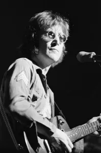 Former singer of The Beatles pop group John Lennon pictured performing on stage during