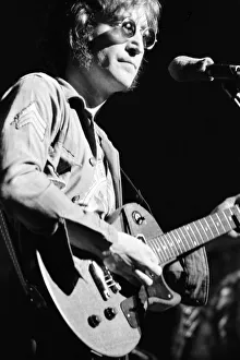 Former singer of The Beatles pop group John Lennon pictured performing on stage during