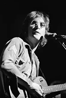 Former singer of The Beatles pop group John Lennon pictured performing on stage during