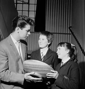 Singer Cliff Richard seen here presenting a school prize of three books to Carol
