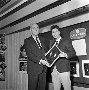 01170 Prints: Singer Cliff Richard with his Silver Disc award for the single I Love You