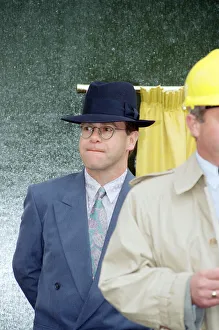 Singer Elton John unveils a plaque to mark the start of work on the AIDS clinic centre
