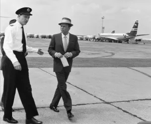 00303 Prints: Singer Frank Sinatra seen here arriving at Heathrow Airport by helicopter