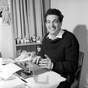 Singer Frankie Vaughan seen here at the typewriter answering some of his fan mail