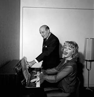 Singer Kathy Kirby playing the piano with her mentor band leader Bert Ambrose