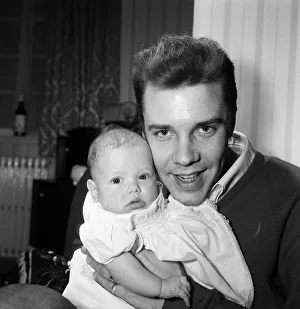 01201 Prints: Singer Marty Wilde at home in Chiswick with his baby daughter Kim. 30th January 1961