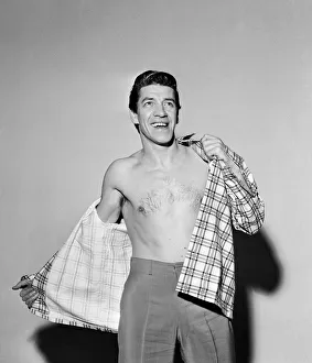 00615 Prints: Singer Michael Holliday poses wearing check shirt. 24th November 1957