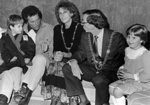 Singer Tom Jones, assisted by his grandson Alexander Woodward