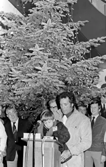 Singer Tom Jones, assisted by his grandson Alexander Woodward