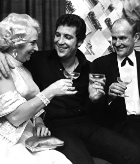 Singer Tom Jones with his parents drinking champagne in his dressing room on the night of