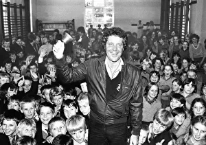 Singer Tom Jones was presented with an old school bell by two youngsters at his old