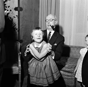 01033 Prints: Sir John Wolfenden playing with 6 year old Belinda Agard at The Savoy