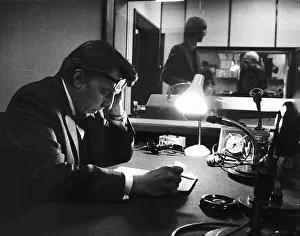 Microphones Prints: Sir Robin Day TV Presenter and Broadcaster sits in a radio studio studying his script