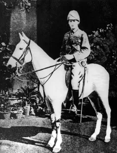 Sir Winston Churchill in khaki service dress outside the bungalow he shared with other