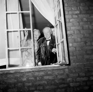 00489 Prints: Sir Winston Churchill and Lady Churchill look from the window of his London home in Hyde