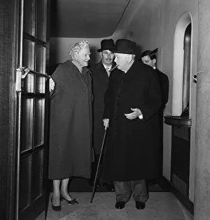 Sir Winston Churchill with his wife Lady Churchill leaving a side entrance of the Savoy