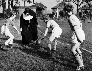 00239 Prints: Sister John Gabriel deputy head mistress coaching the schools football team. 1965