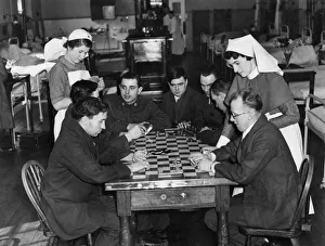 00035 Prints: Sister Shine (right) and nurse Cockin playing cards with a group of boys in blue
