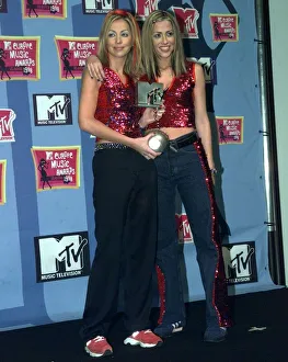 Sisters Natalie Appleton and Nicole Appleton of pop group All Saints pick up their award