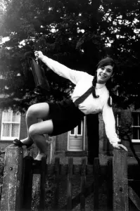Sixteen year old Katie Kirke jumps over the gate on her way to school