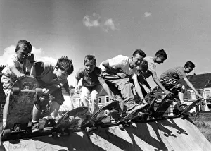 Skateboard Prints: Some skateboard riders prepare for action on the ramp on 17th August 1989