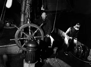 00156 Prints: Skipper Harry Evans at the wheel of the Thames sailing barge Ardwina as she rounds Beachy