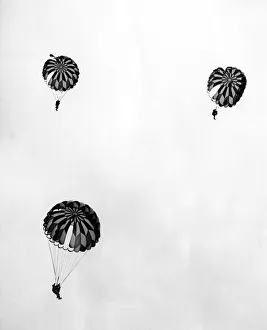 Annual Prints: Sky Divers, the daredevil Special Air Services parachute team jumped 2500 feet to a