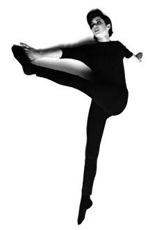 Keep Fit Prints: Slimming - Exercises 1960s. Woman performing stretches. Circa 1966