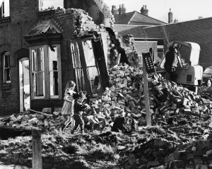 Derelict Prints: Slum housing in Birmingham. Children play and collect firewood amongst the wreckage