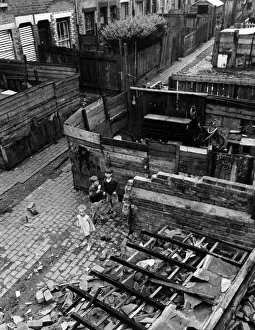 Slums Prints: Slum housing in Birmingham. June 1967 Children play amongst the wreckage