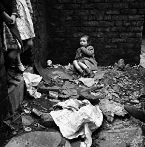 Rubble Collection: Slum housing in Salford. Four year old Lyn Greenhalgh. The rubble is hers to play with
