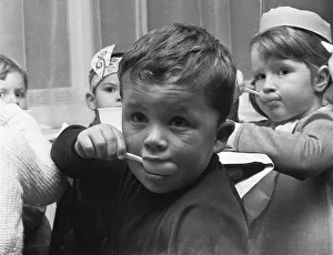 A small boy enjoying his jelly and ice cream during the Birch Copse School Christmas