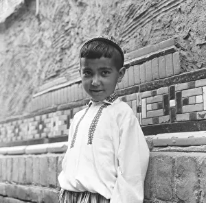 Rusia Prints: Small boy seen here dressed in the national costume of the central steppes of Russia
