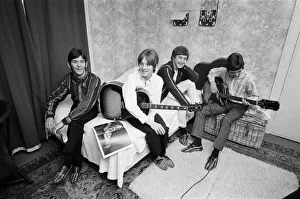 The Small Faces pop group pictured in a provincial hotel room as they watch their latest